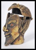 A brass cased vesta in the form of a devils head with inset red stone eyes. AF