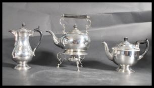 A silver plate picnic kettle spirit burner on scrolled tripod base , a water jug with scrolled