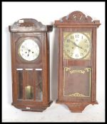 A 1920's oak cased wall clock with 8 day movement and silvered dial together with another