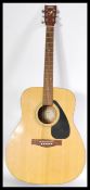 A 20th Century six string acoustic guitar by Yamaha, applied paper label reading Yamaha F310