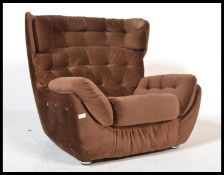 A vintage 20th century retro low brown armchair / lounge chair with button back detailing. Measures: