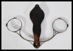 A 19th century Georgian pair of lorgnettes of tortoiseshell construction having twin silver white