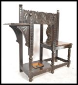 A 19th century Victorian carved oak Jacobean revival hall settle seat chair of unusual form having a