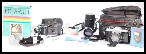 A vintage retro boxed Polaroid Land camera together with a cased Pentax 35mm camera,lens and