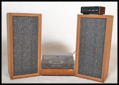 A retro 1970's teak cased and acryllic hood record player having inset Garrard deck being complete
