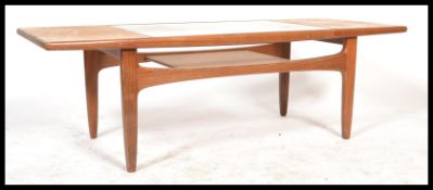 A 1970's retro G-Plan teak wood coffee table of rectangular form raised on tapering legs with