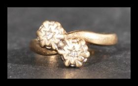 A hallmarked 9ct gold and diamond ring having star set diamonds in a crossover style. Import mark