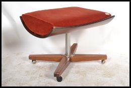 A vintage mid 20th century retro G-Plan stool of saddle form raised on an X base with chrome stem.