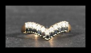 A hallmarked 9ct gold wishbone ring set with sapphire and diamonds. Diamonds approx 33pts.