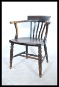 An early 20th century Beech and elm wood office Industrial desk chair / smokers bow armchair being