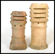 2 early 20th century stoneware chimney pots of large form with shaped and vented tops on cylindrical