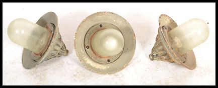 A group of three vintage retro 20th century space age style GEC industrial caged bulk head lights.