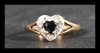 A hallmarked 9ct gold sapphire and diamond ring in the form of  heart. Weight 1.5g. Size M.5.