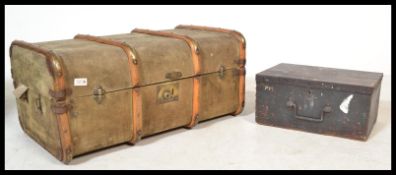 A vintage retro 20th century canvas bound steamer trunk suitcase along with an ebonised wooden