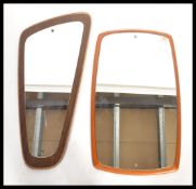 Two vintage retro 20th century teak frameless mirrors one of oblong form and the other