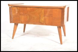 A 1950's Post war Art Deco style walnut sewing box with contents. Raised on turned legs with a