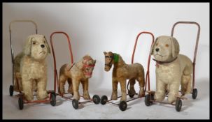 A good collection of vintage mid century childs ride on dogs together with 2 smaller push along
