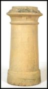 An unusual early 20th century stoneware chimney pot having shaped top on cylindrical body with