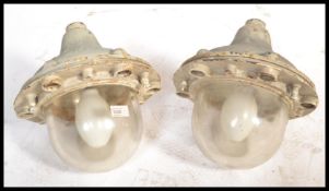 A pair of vintage retro 20th century space age style GEC industrial caged bulk head lights. Each