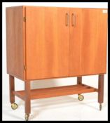 A 1970's vintage teak wood media cabinet,record player unit with double doors and magazine rack