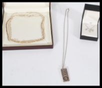 A group of sterling silver necklaces to include an ingot pendant necklace , rope twist , Singapore