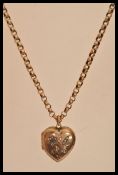 A 9k gold belcher link necklace chain having a rolled gold heart locket pendant. Chain weighs 6.9