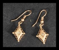 A pair of early 20th century 9ct gold and diamond drop earrings. Unmarked, tests 9ct gold and