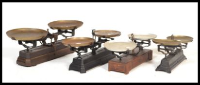 A set of three vintage early 20th Century pan scales, set to heavy cast bases.