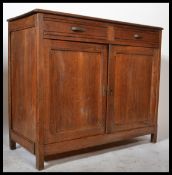 An early 20th Century rustic French Elm Buffet sideboard having two drawers over two panel doors and