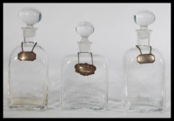 A group of three Glen Dartington Decanters designed by Frank Thrower all with silver hallmarked