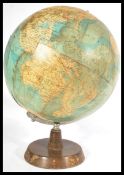 A vintage mid century Philips desk top terrestrial globe raised on a circular wooden base. Makers