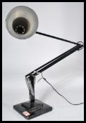 A 1940's Industrial pre-war Herbert Terry anglepoise lamp, raised on a cast metal two step base with