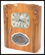 A French walnut Avron eight day wall clock, the rectangular dial with canted corners set with