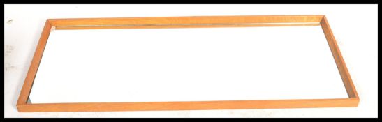 A vintage  retro oversized wall hanging shop mirror, teak angular frame with a central mirror panel.