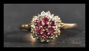 A hallmarked 9ct gold ruby and diamond cluster ring. Hallmarked Birmingham. Weight 2.1g. Size P.