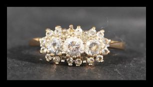 A hallmarked 9ct gold cluster ring set with white stones. Hallmarked London. Weight 2.4g. Size Q.5.