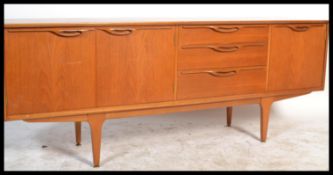 A retro 20th Century Danish inspired teak sideboard, having a series of drawers and cupboards raised