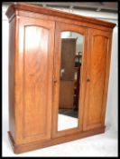 A Victorian 19th century mahogany linen press - triple wardrobe. Raised on a plinth base with a