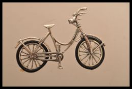 A sterling silver vintage style miniature model of bicycle with rubber tires. Weighs 10.9 grams.