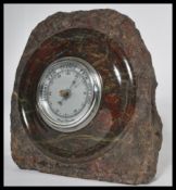 An early 20th century Art Deco carved Cornish Serpentine Marble Aneroid Barometer. Inset circular