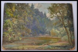 An early 20th century oil on board painting of ducks near a river with masses of trees and foliage