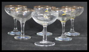 A group of six vintage Babycham glasses each featuring the iconic Babycham Faun. Highest measures 11