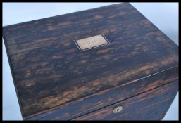 A 19th century coromandel workbox having hinged top with tooled leather and velvet lined top. The