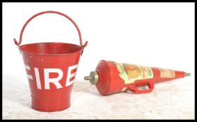 A vintage retro 20th century red painted metal fire bucket along with a mid century fire