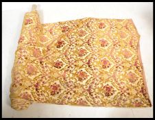 A good quality roll of vintage upholstery fabric on a cream ground with floral motifs and scroll