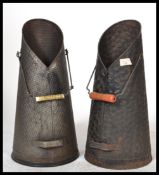 A pair of vintage early 20th Century coal scuttles, each of tapering conical form with carry