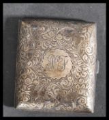 A silver hallmarked hinged chase decorated cigarette case, assay marks for Birmingham, dating to