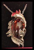 A silver and marcasite necklace pendant in the form of a parrot in presentation box.