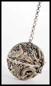 A 19th century Chinese silver incense ball / puzzle ball depicting dragons chasing the flaming