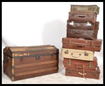 A collection of vintage 20th Century suitcases to include leather examples together with a vintage